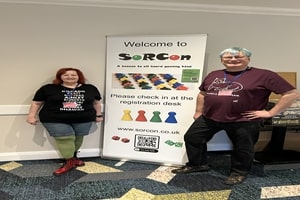 Comittee members standing by Welcome to Sorcon sign